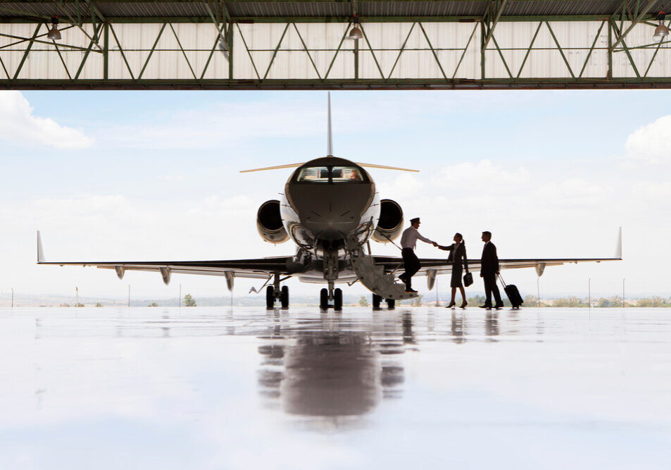 Silhouette,Of,Pilot,Greeting,Businessman,And,Businesswoman,Boarding,Private,Jet